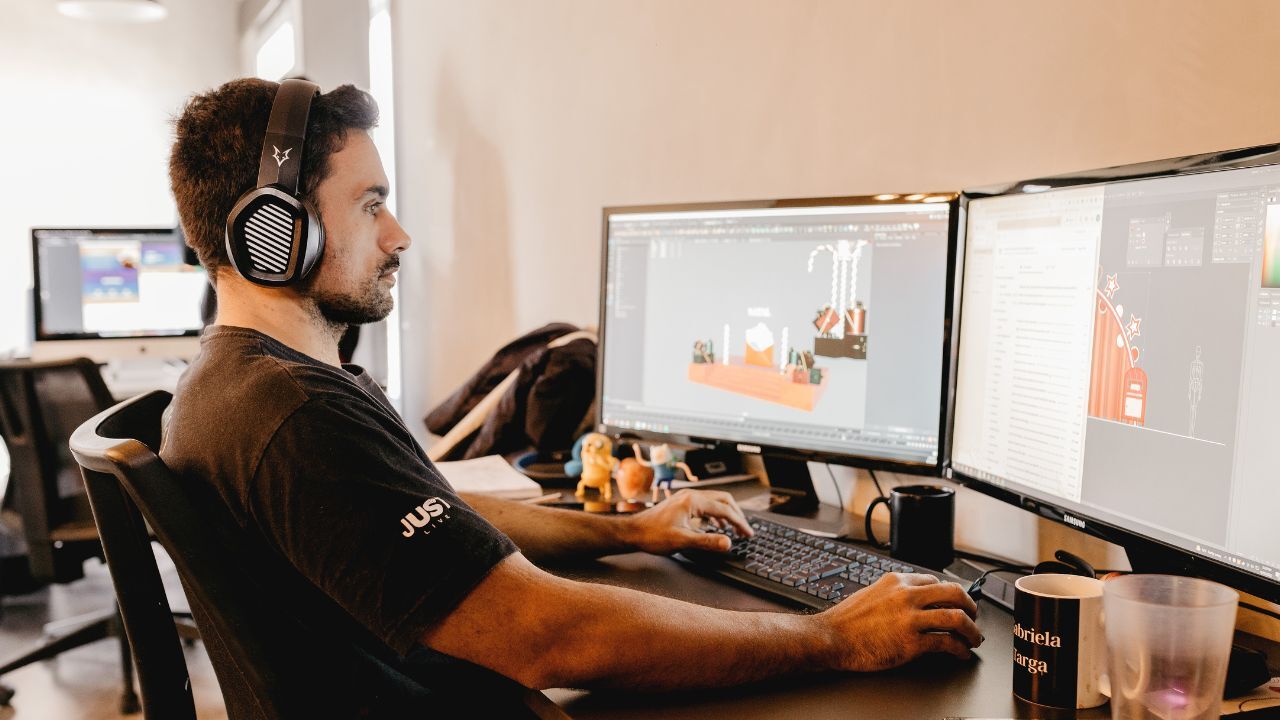 A man working at his desk with a computer
