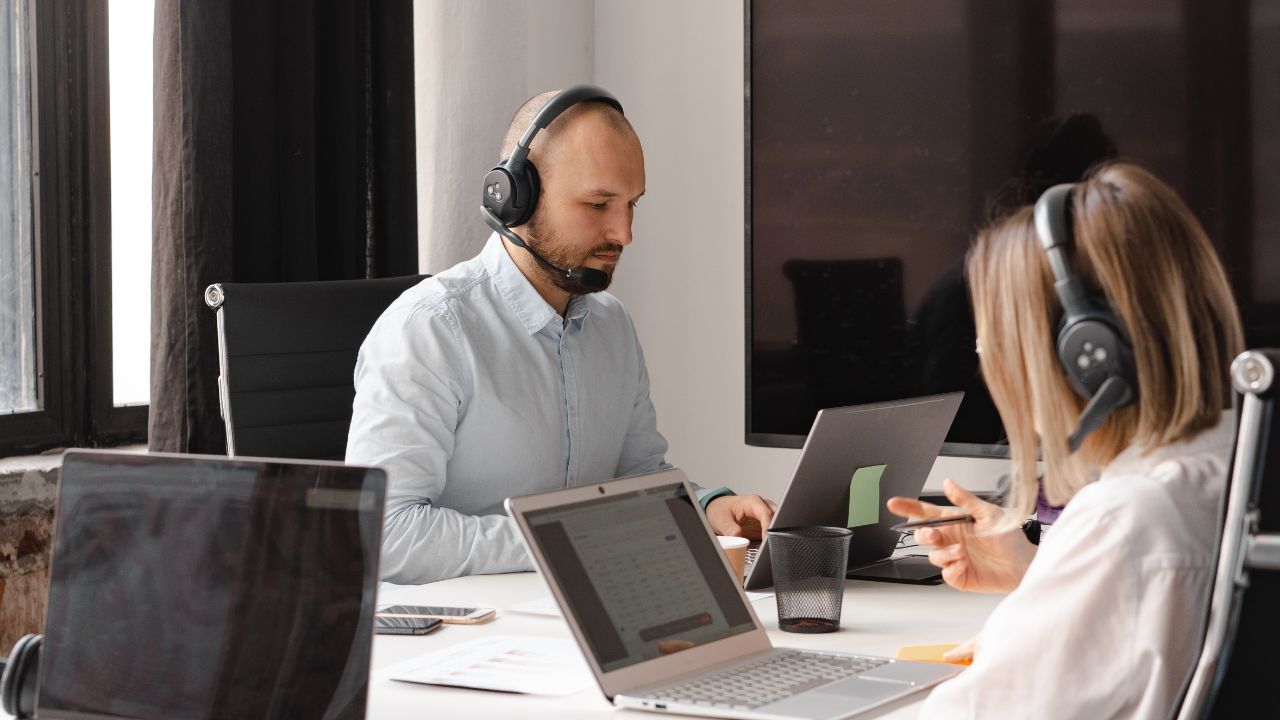 A customer service representative working at his desk